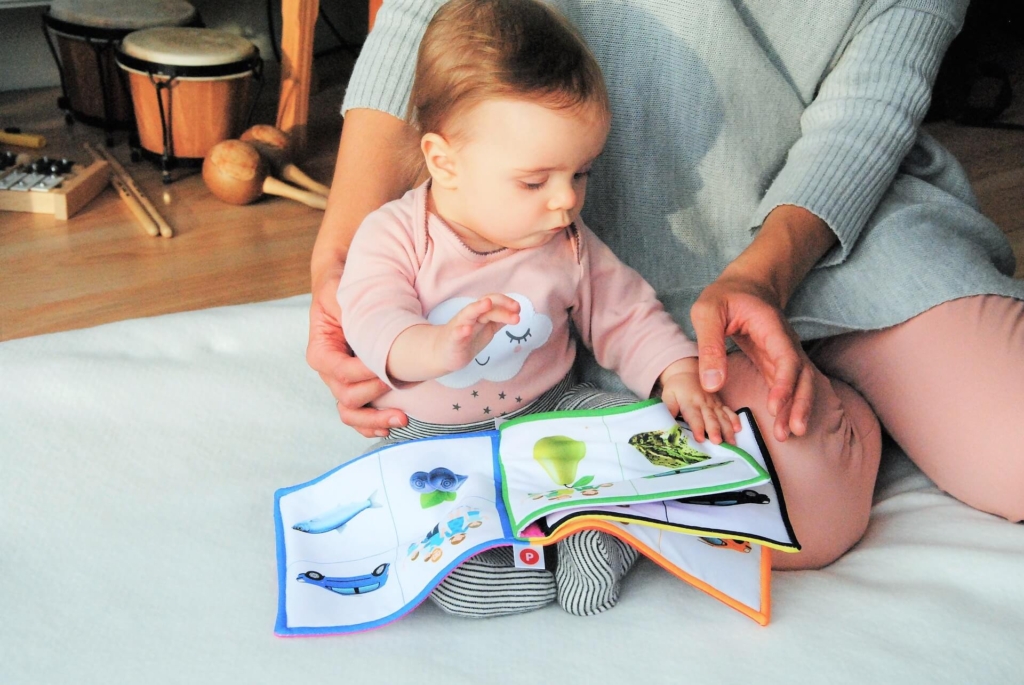 Baby-reading-picture-book-with-mam