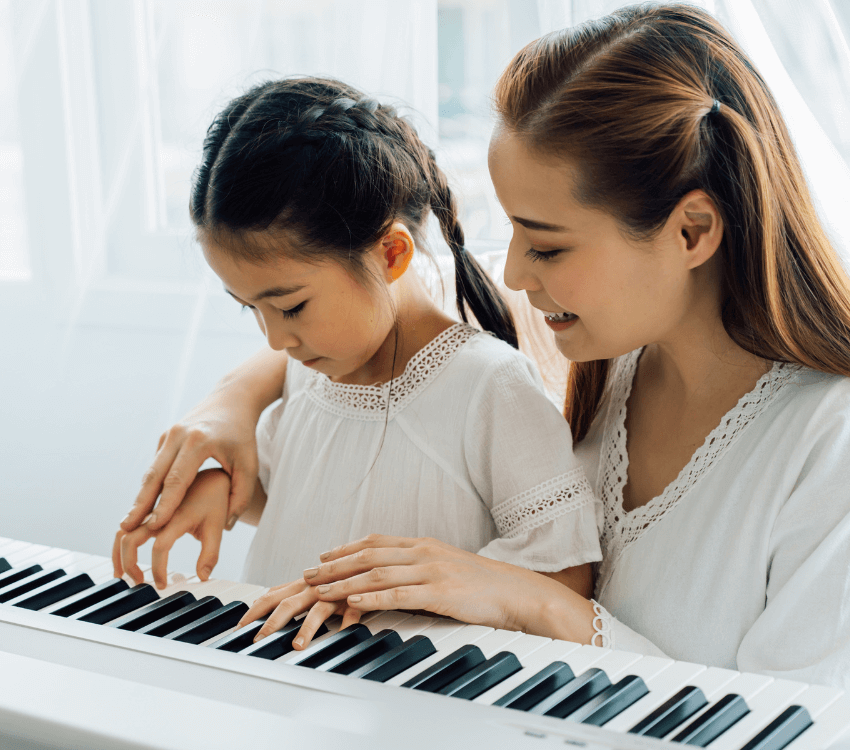 Parents -and -children -playing -the -piano -together
