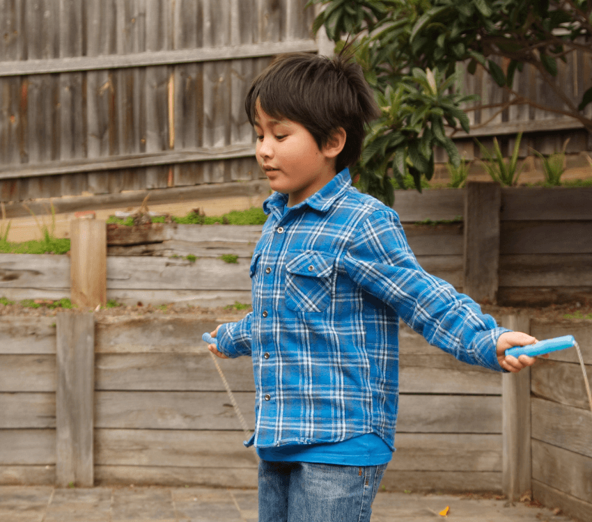 Child- trying -to -button- a- button