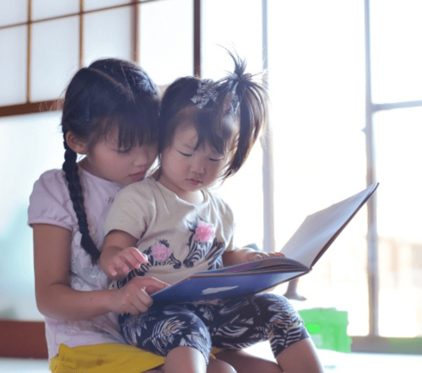 sister- reading- a -picture-book