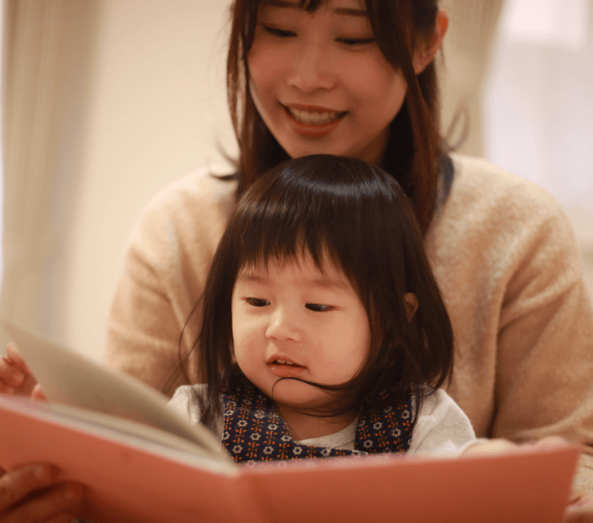 A- child -having- his -mother- read -a -picture- book